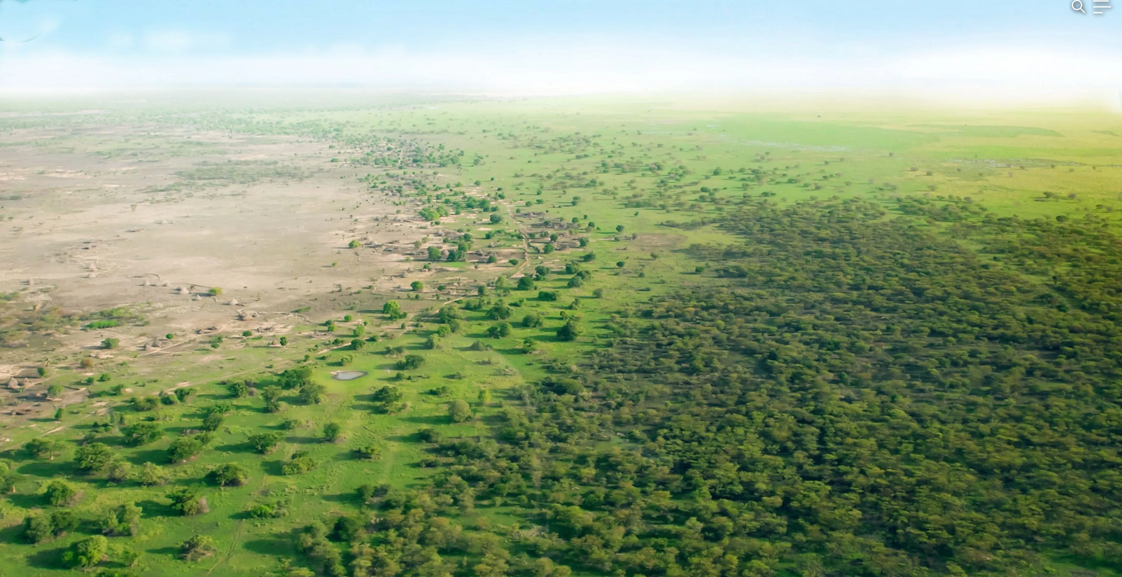 Aerial view of a green strip of restored land cutting across the desert.